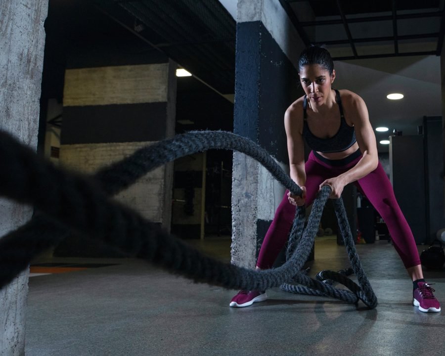 Woman training with battle ropes